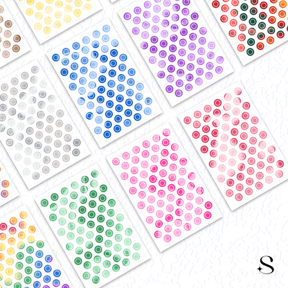 Collection of small round cute journal stickers in various colors on a white background